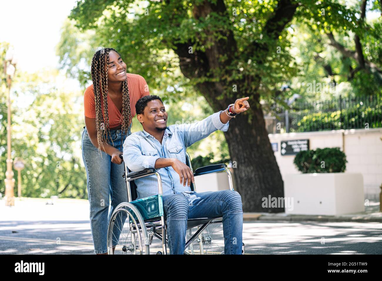 Man in a wheelchair enjoying a walk with his girlfriend Stock Photo - Alamy