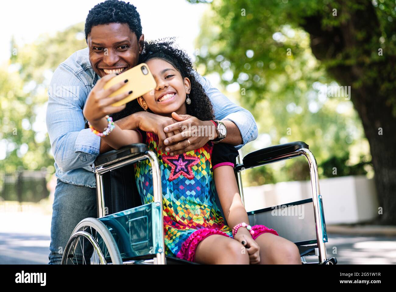 Girl in a wheelchair and her father taking a selfie with phone Stock ...