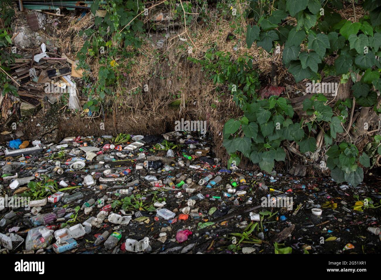 Trash, mostly a variety of plastics, float on the heavily polluted San Juan River, a tributary of Pasig River, in Mandaluyong City, Philippines, June 21, 2021. Picture taken June 21, 2021. REUTERS/Eloisa Lopez Stock Photo