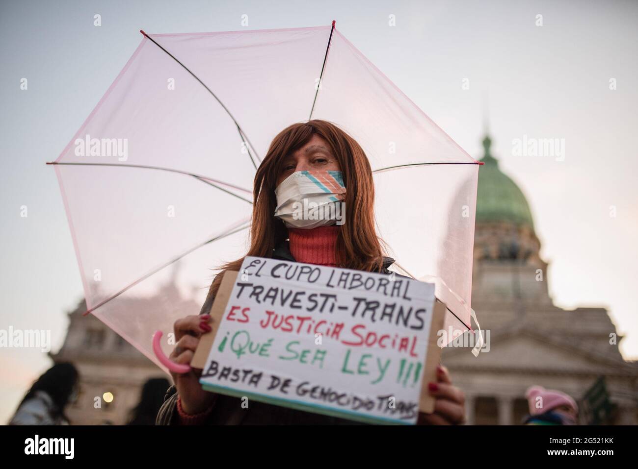 Buenos Aires, Argentina. 24th June, 2021. A person holding a placard waits for the vote of the law. Voting and approval of the work quota for transvestites and transgender people in Argentina, a large group of people gathered outside the Congress of the Argentine Nation to hold a vigil awaiting the result of the vote of the Senate, which ended in the approval of the Law. Credit: SOPA Images Limited/Alamy Live News Stock Photo