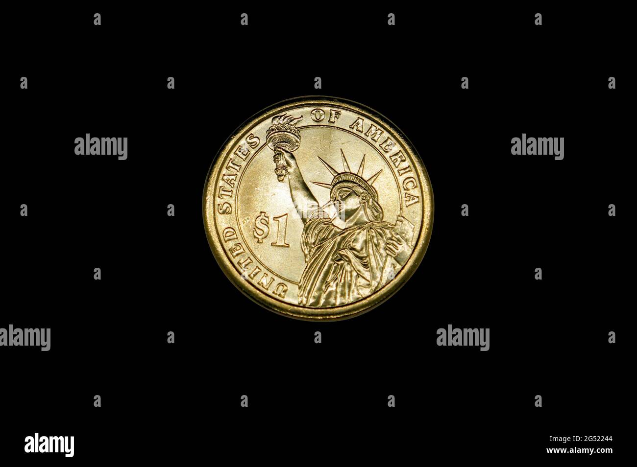 Golden one dollar coin with the image of the Statue of Liberty isolated on black Stock Photo