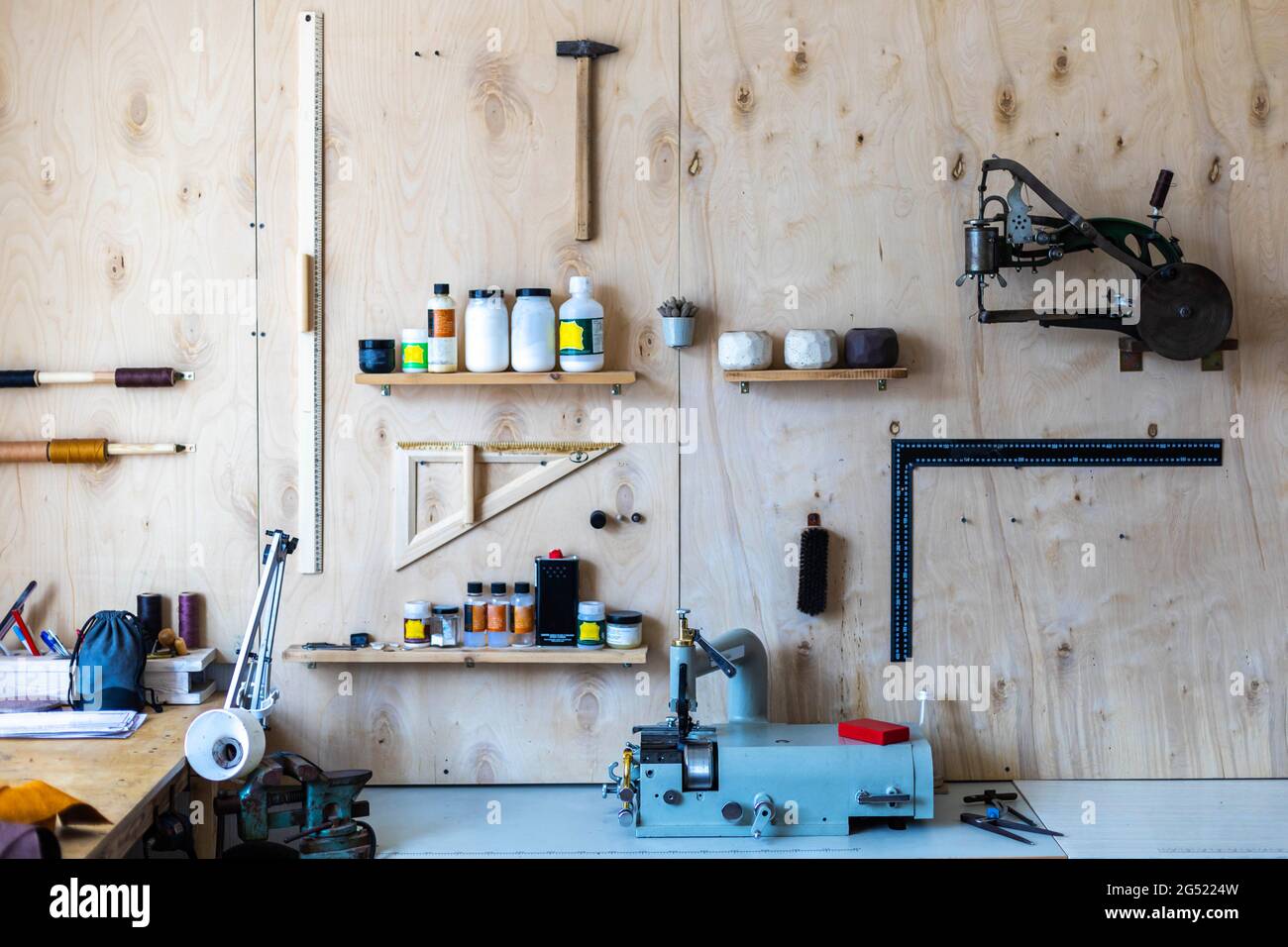 Wooden wall at leather Different tools and equipment for