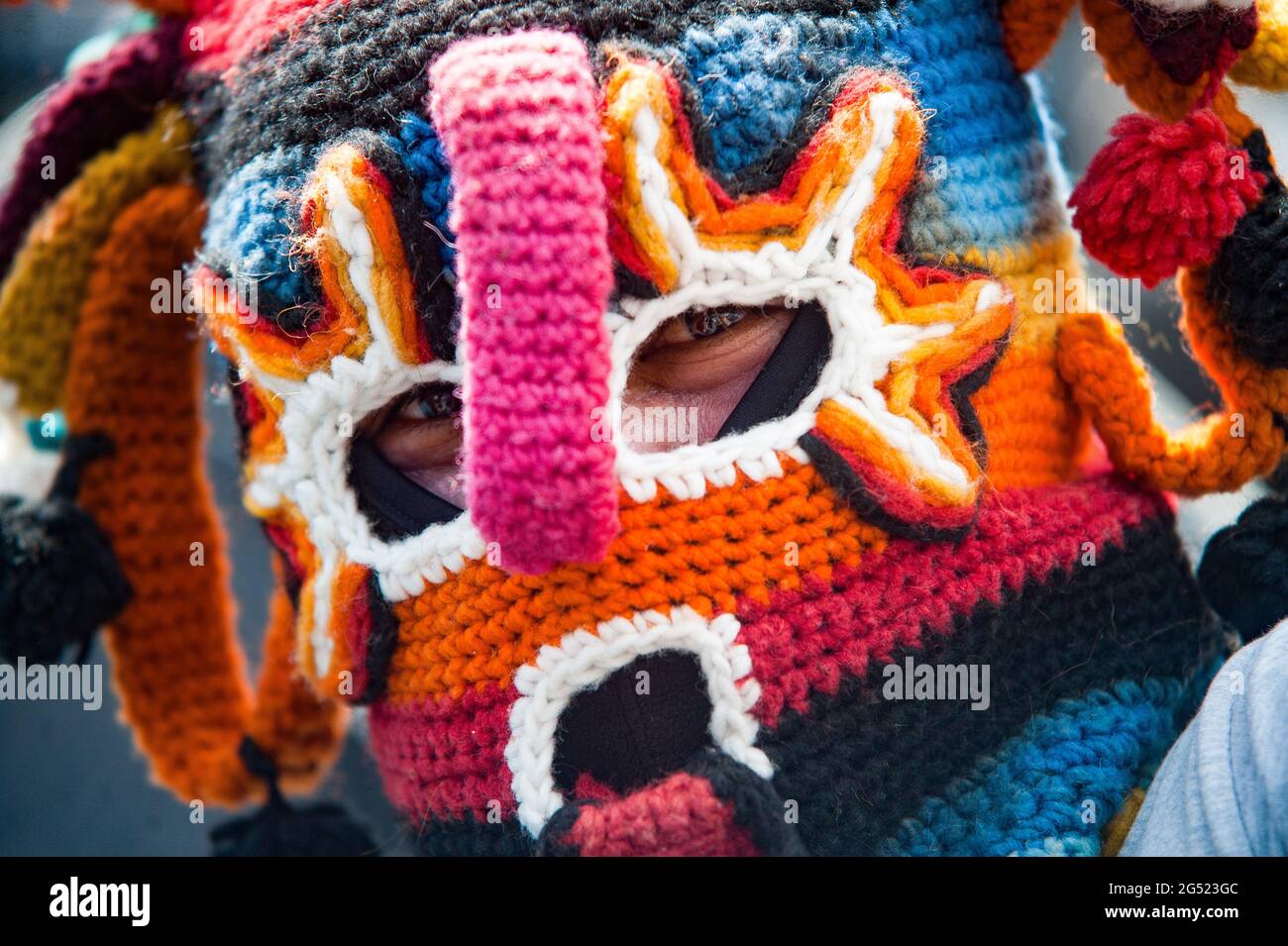 A man wearing a traditional Devil Huma's mask, a spirit of the Andean  worldview seen during the event. Within the framework of the indigenous  festivities by INTI RAYMI in Ecuador, the Taking