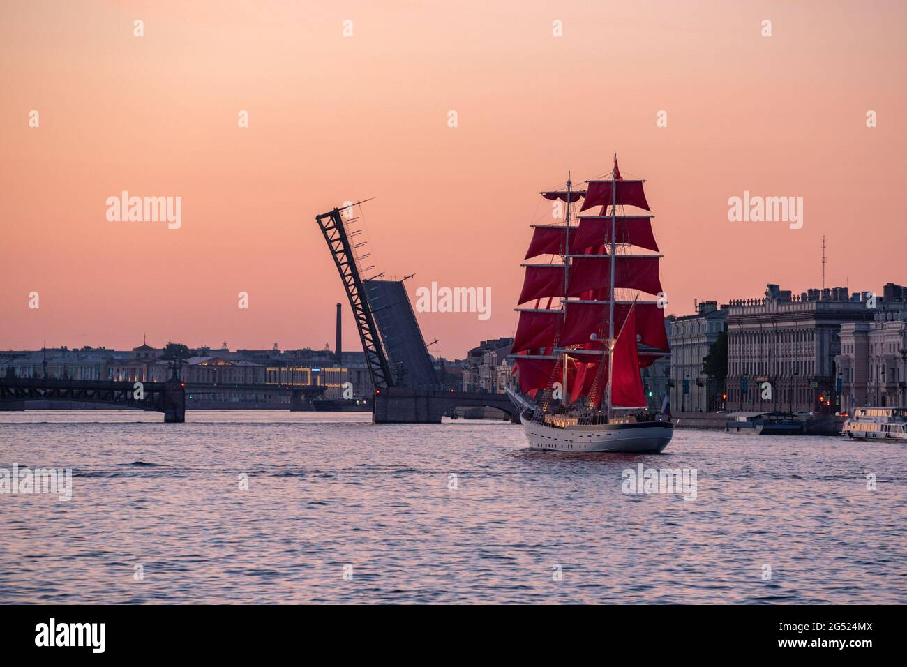 Saint Petersburg, Russia - June 10, 2021: a brig Rossiya sails beside Trinity Bridge on the Neva River at sunrise. Stock Photo