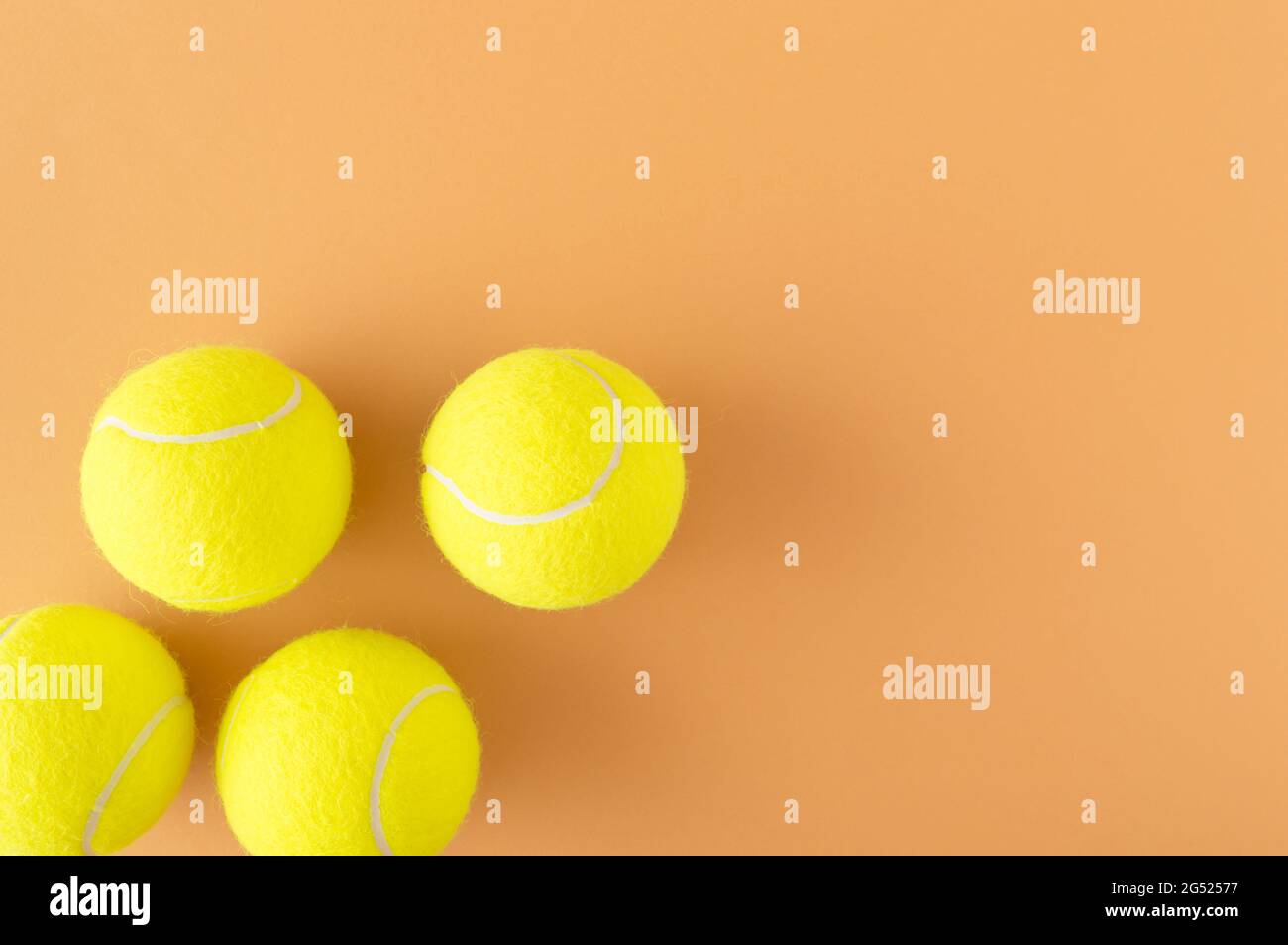 Tennis balls spontaneously arranged in a corner with a large copy space. Sports competition in tennis concept Stock Photo