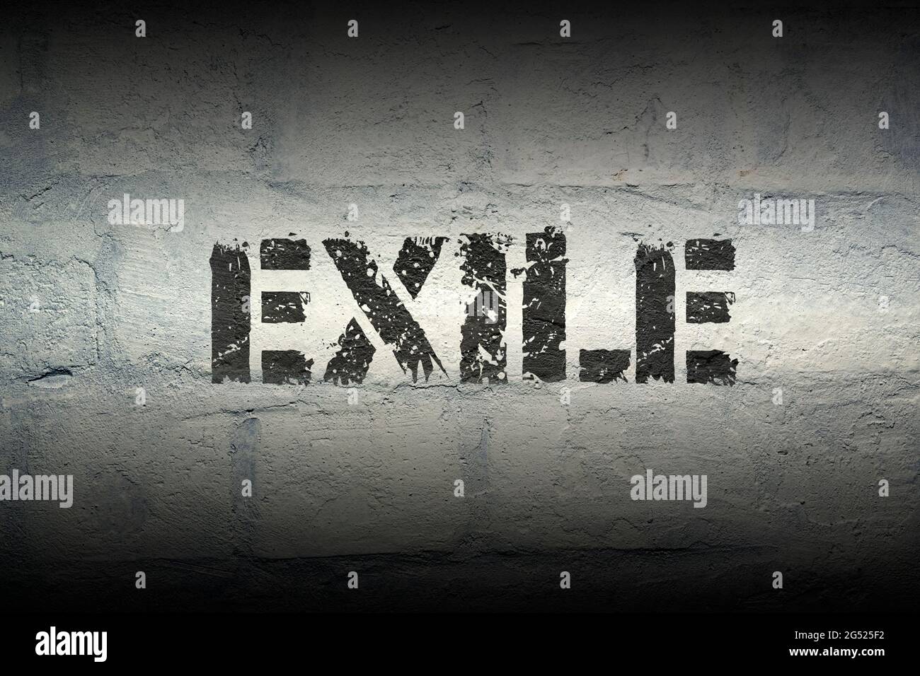 exile stencil print on the grunge white brick wall Stock Photo - Alamy