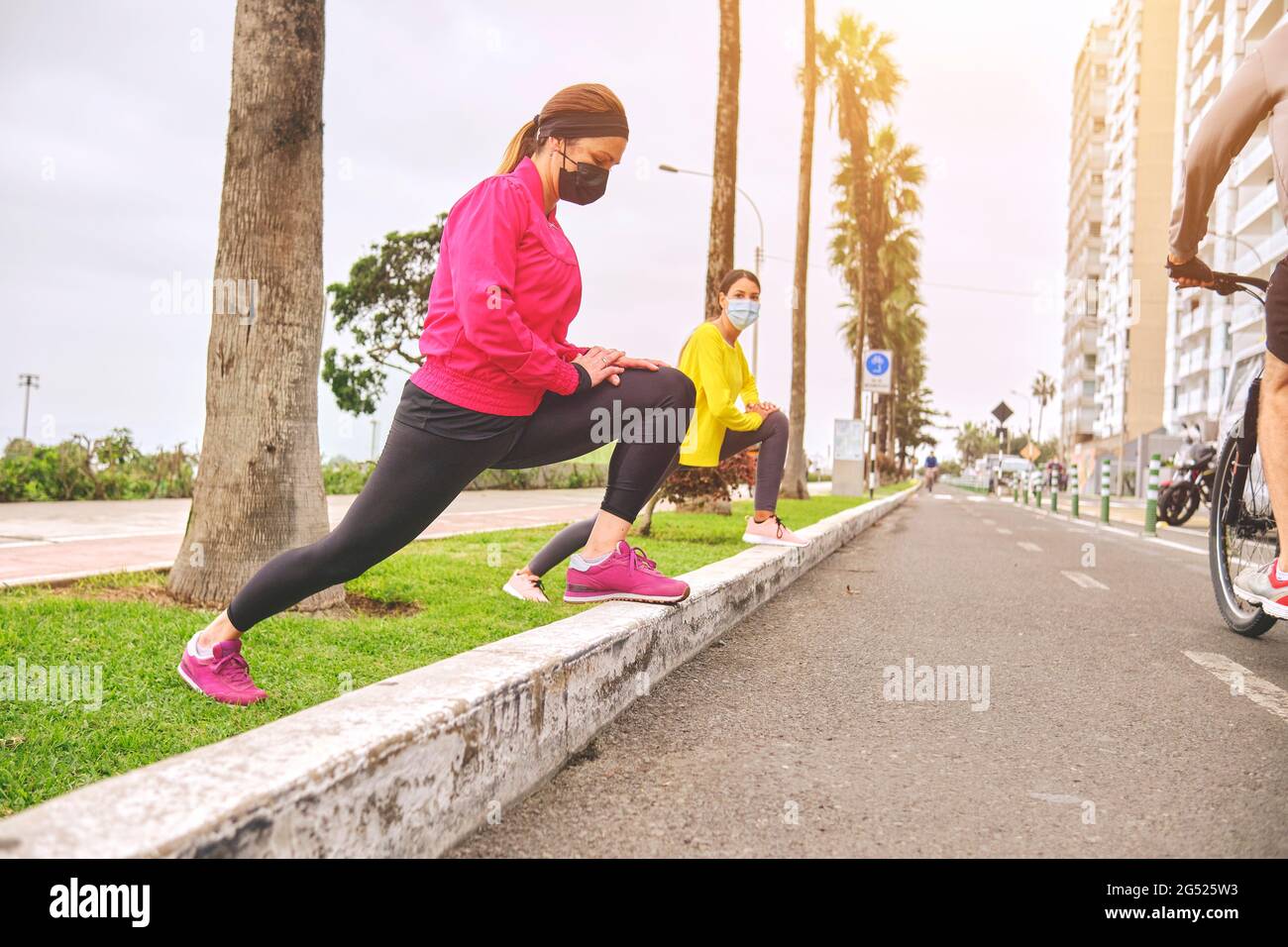 Two Sporty Women Jogging In A Park Wearing Sports Bras Stock Photo