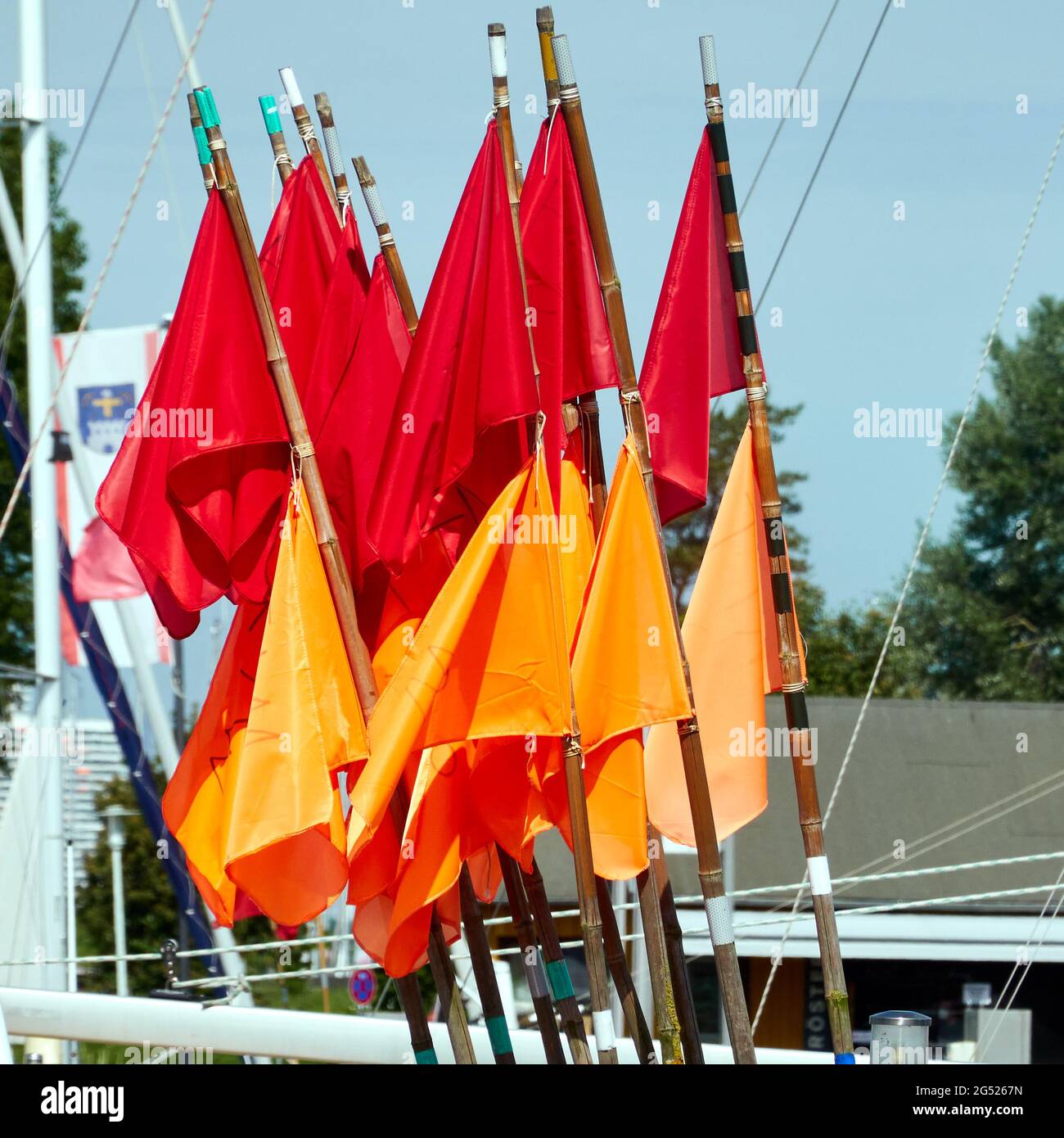 Red and orange flags on poles used by fishermen in the Baltic Sea to