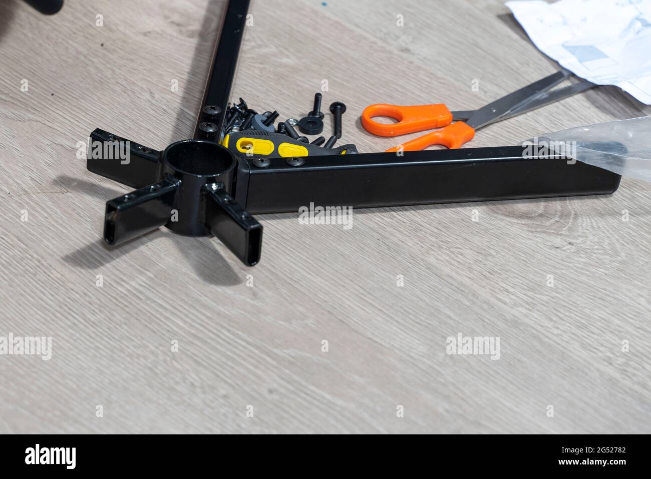 a man assembles a new chair at home. Stock Photo