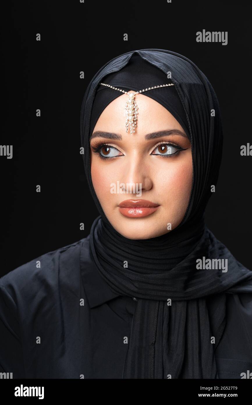Portrait of a young muslim woman in hijab on black background Stock ...
