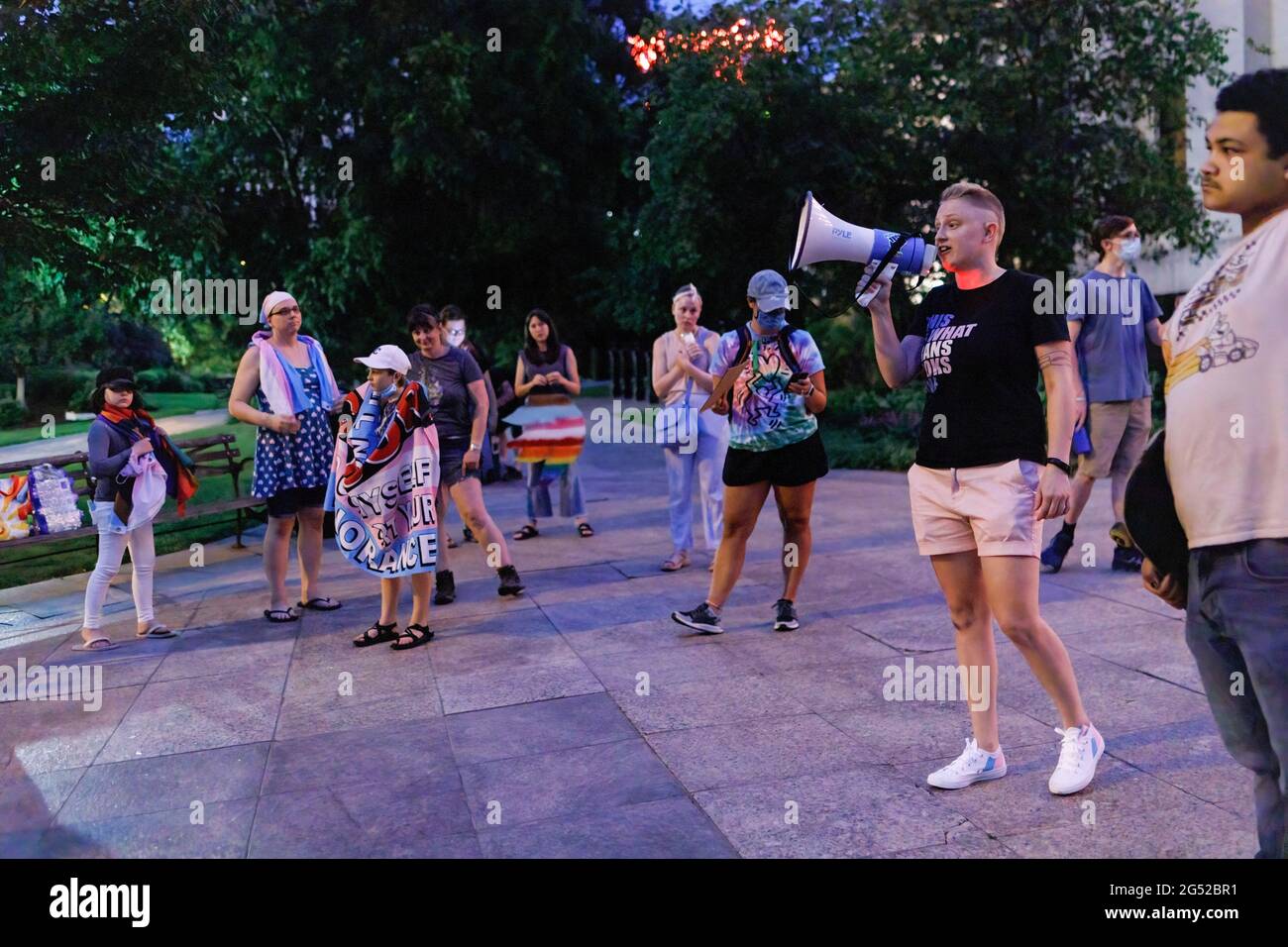 Lena Tenney, 29, of North Linden speaks on a megaphone during a night time rally against legislation that would ban transgender women from participating in girlís/womenís sports. Transgender rights advocates stood outside of the Ohio Statehouse to oppose and bring attention to an amendment to a bill that would ban transgender women from participating in high school and college women sports. The original bill that this transgender ban was added to dealt with compensation for college students to profit off of their name, image and likeness. The addition of transgender ban to this bill was a sur Stock Photo
