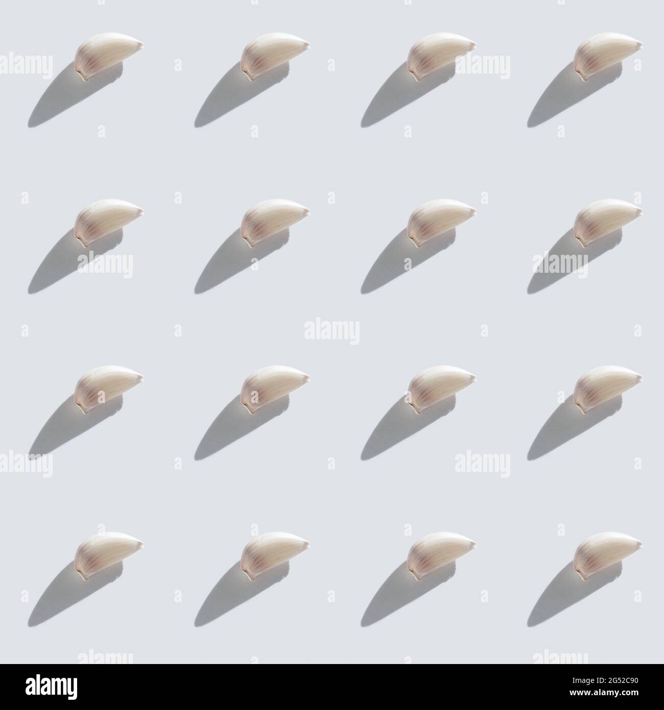Pattern made of garlic cloves on grey background top view. Cooking blog ...
