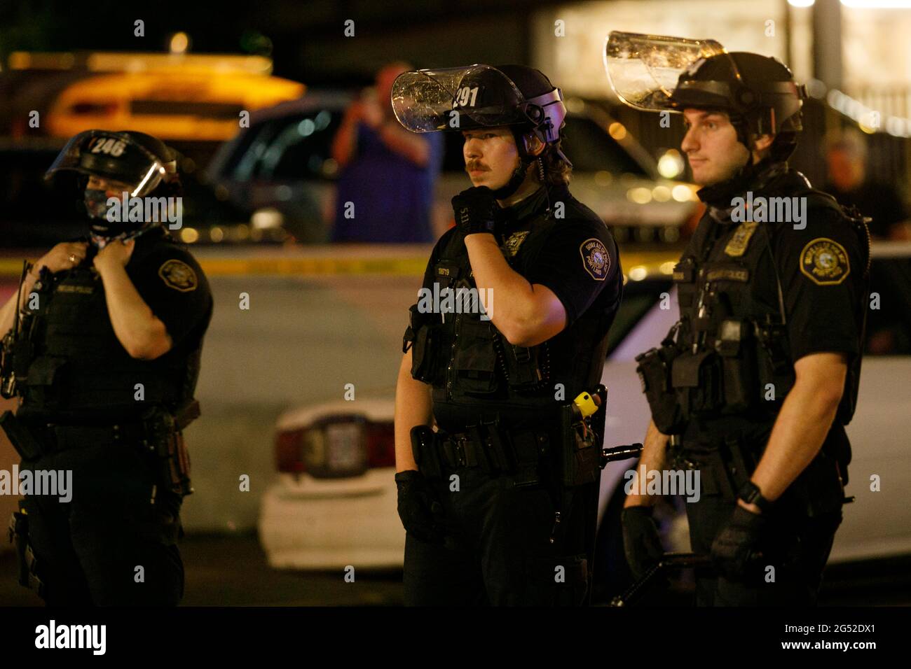 Portland, USA. 24th June, 2021. Police don riot gear as an agry crowd gathers. Police shot and killed one man during uncertain circumstances at approximately 7 PM PST on June 24, 2021 in Portland, Oregon. His death was announced at 12:37 am on June 25; police have not released any details of the shooting; and an angry crowd has gathered at the scene of the shooting in Northeast Portland. (Photo by John Rudoff/Sipa USA) Credit: Sipa USA/Alamy Live News Stock Photo