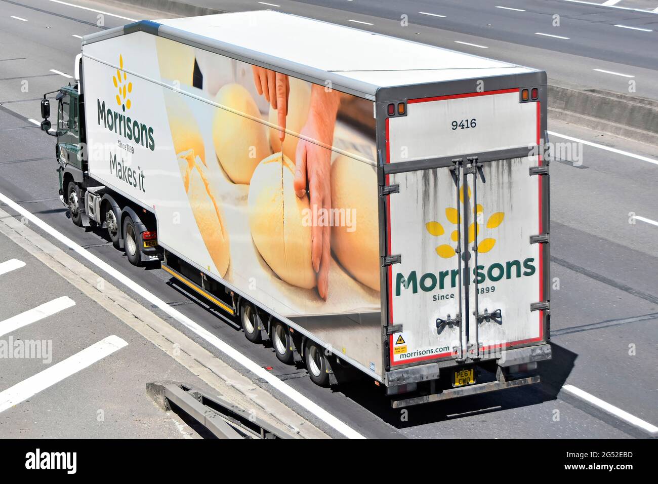 Side back & top view of Morrisons supermarket lorry truck advertising graphics brand name logo on store delivery food supply chain trailer UK motorway Stock Photo