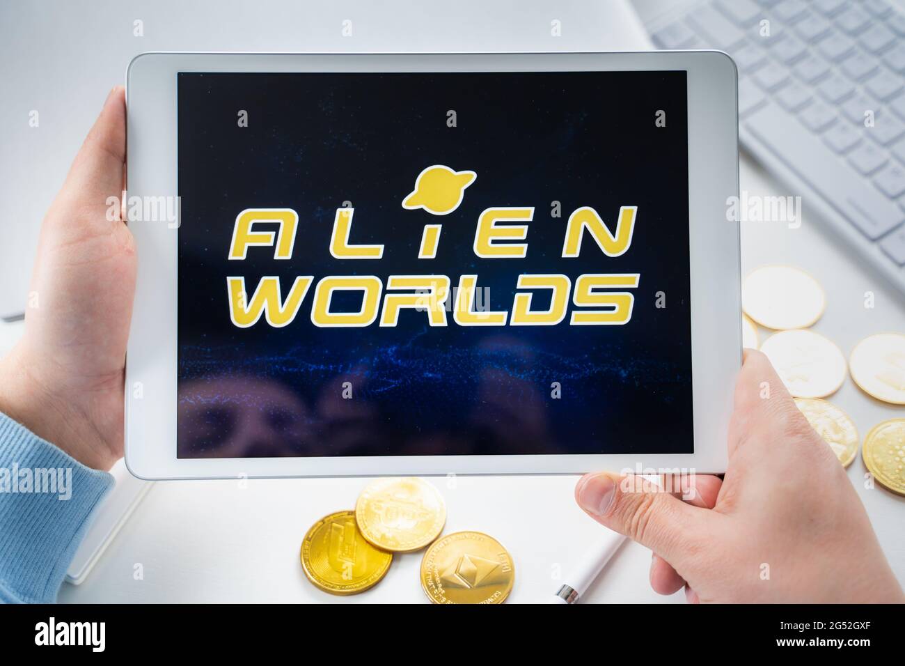 Russia Moscow 05.05.2021. Man holding tablet with logo of gaming platform  Alien Worlds. Crypto coins,tokens mining online game. NFT staking  system.Cry Stock Photo - Alamy