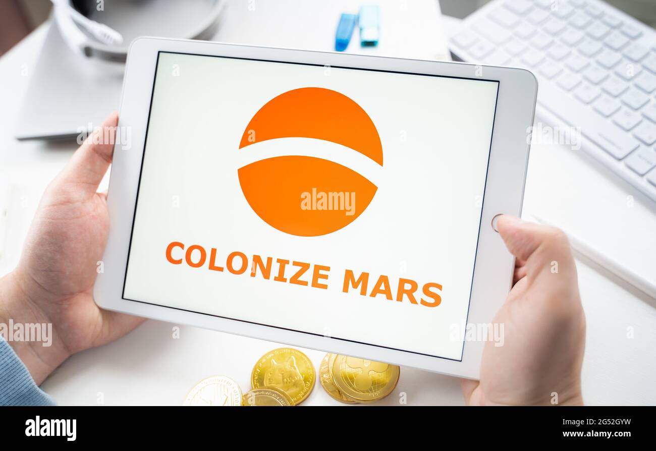 Russia Moscow 05.05.2021. Man holding tablet with logo of gaming platform Colonize  Mars.Crypto coins,tokens mining online game.NFT staking system.Cryp Stock  Photo - Alamy