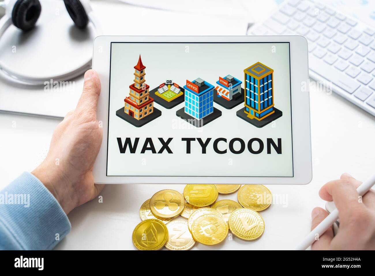 Russia Moscow 05.05.2021. Man holding tablet with logo of gaming platform  WAX TYCOON. Crypto coins,tokens mining online game. NFT staking  system.Crypt Stock Photo - Alamy