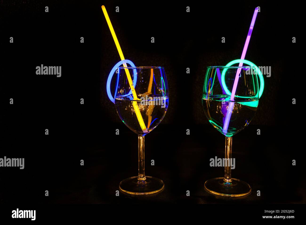 Holiday party refreshment drink in a bar wine glass colorful light reflection with dark background for holidays, christmas, new year and gathering lei Stock Photo