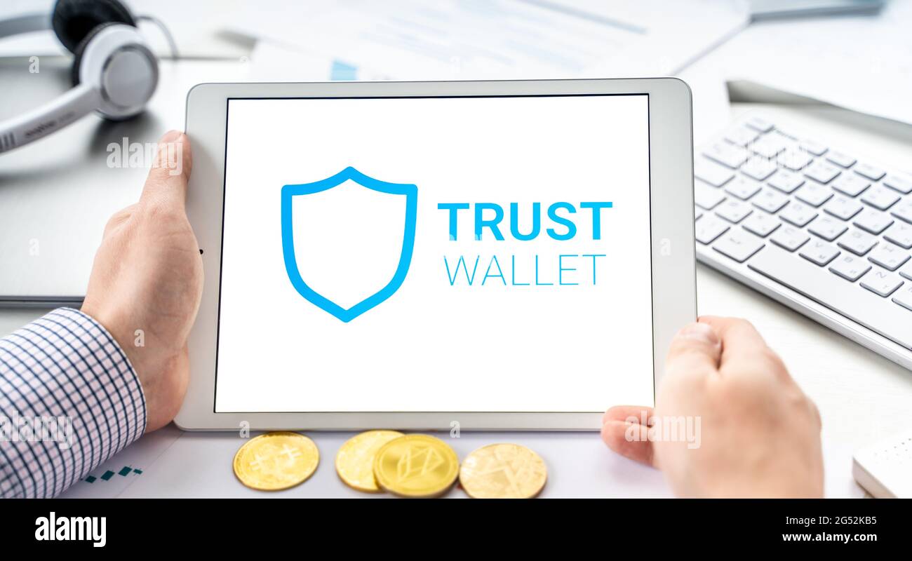 Russia Moscow 06.05.2021 Businessman, tablet. Logo of software cryptocurrency  wallet,gateway Trust Wallet. Blockchain application to buy,store,send,sw  Stock Photo - Alamy