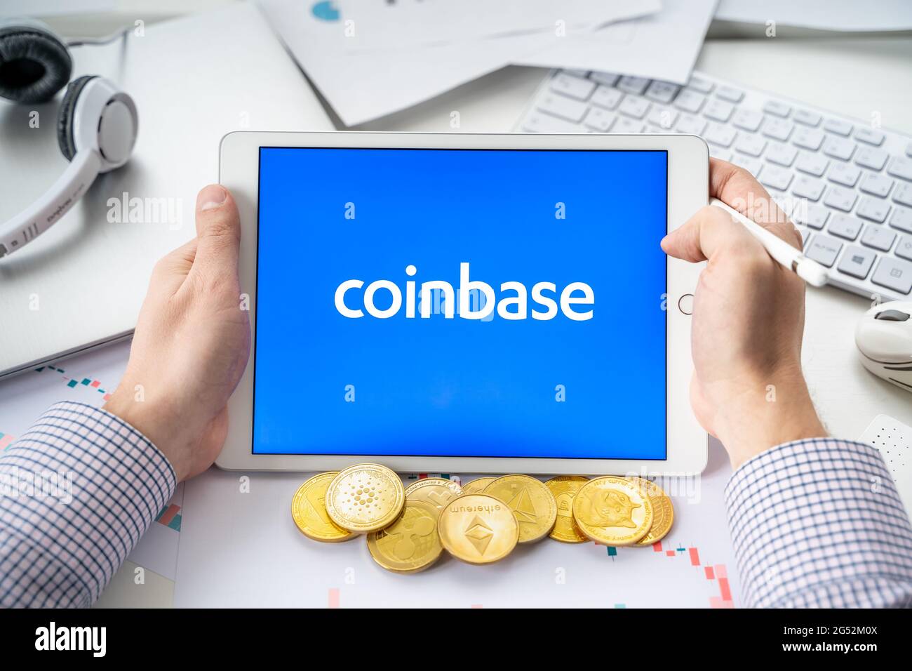 Russia Moscow 06.05.2021.Businessman with tablet.Logo of cryptocurrency stock exchange Coinbase.Trading blockchain platform to buy,sell digital crypto Stock Photo