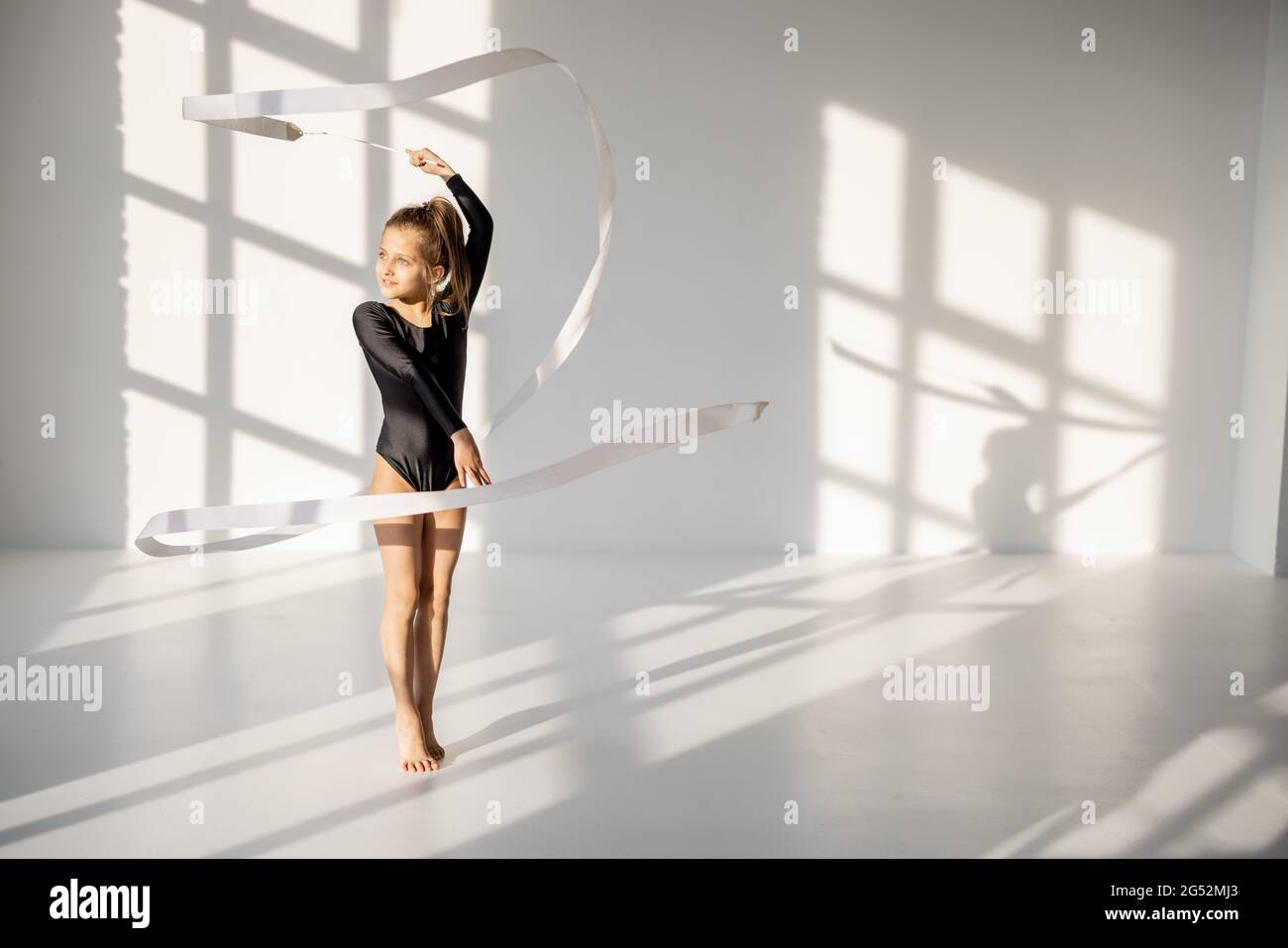 Little girl practising rhythmic gymnastics with a tape Stock Photo Alamy