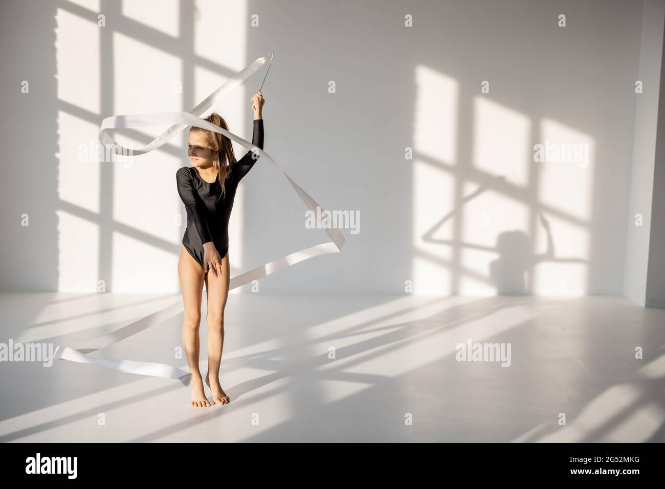 Little girl practising rhythmic gymnastics with a tape Stock Photo Alamy