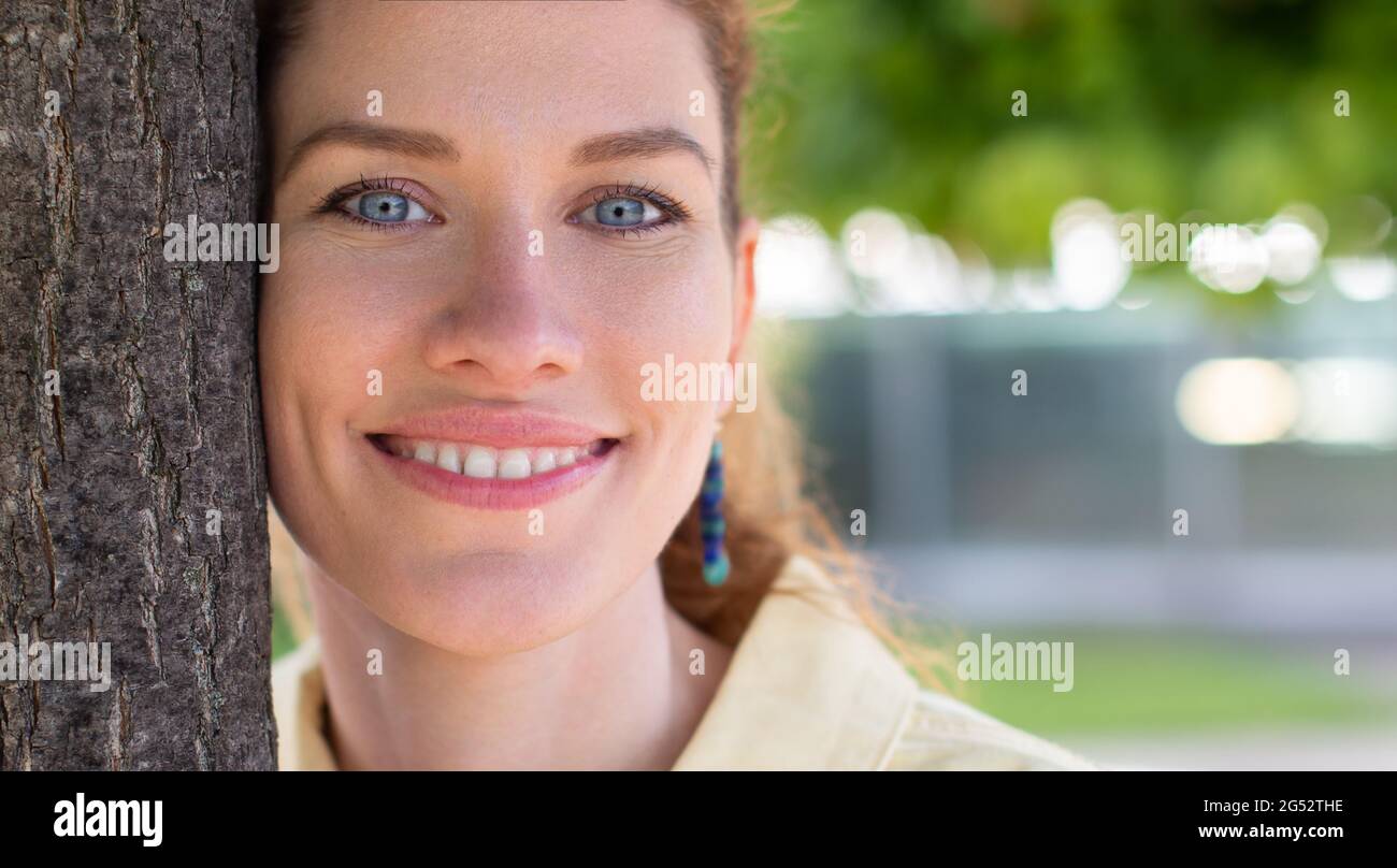 Beautiful natural Caucasian woman in park closeup Stock Photo