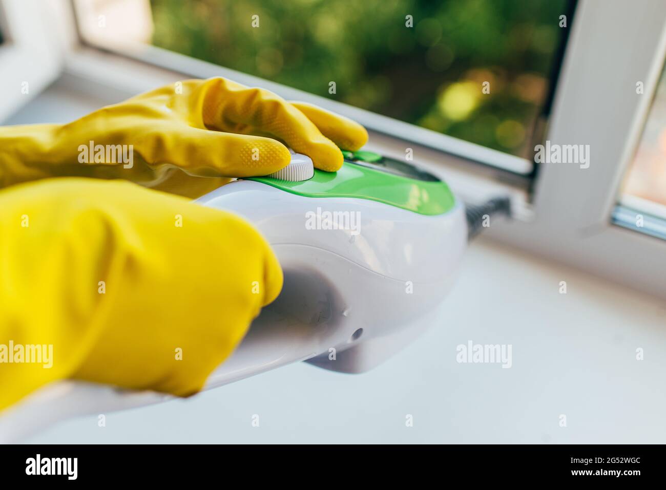 A gloved person adjusts the power of the steam cleaner Stock Photo - Alamy