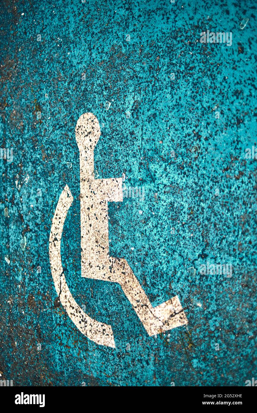wheelchair lane sign painted on the ground in a disabled parking space. Stock Photo