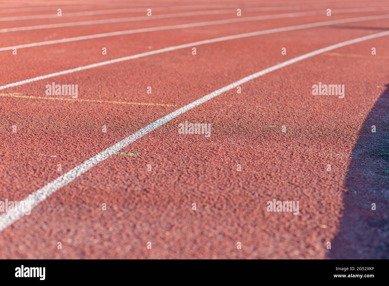 Part Red plastic track in the outdoor track and field stadium.Closeup. Stock Photo