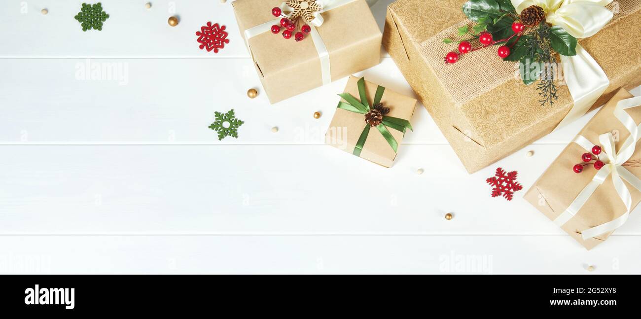 Christmas banner with border of gift boxes on white wood background ...