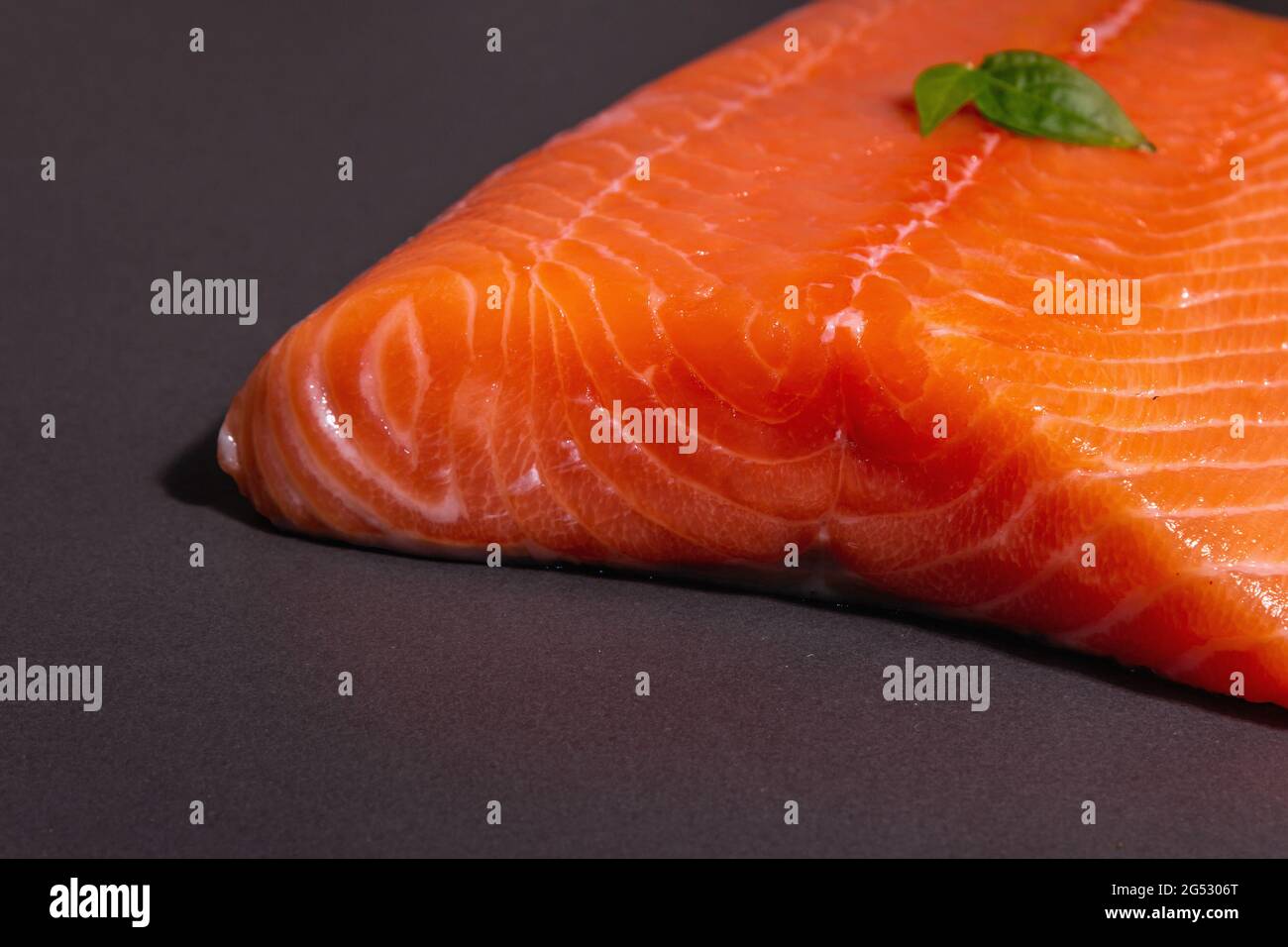Fresh raw salmon or trout sea fish fillet on black stone background ...