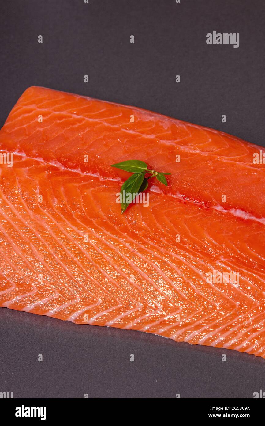 Fresh raw salmon or trout sea fish fillet on black stone background ...