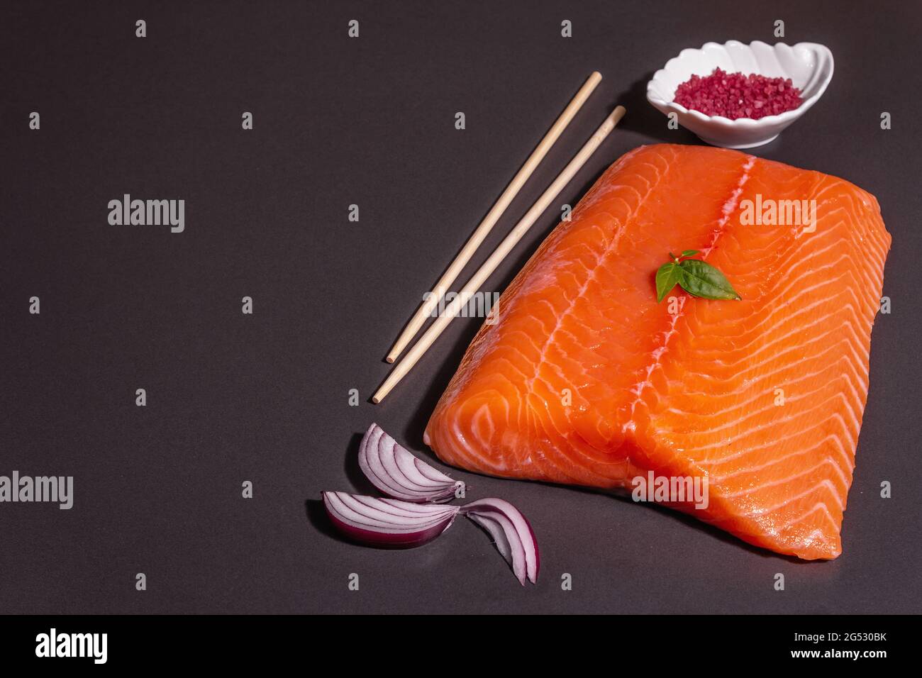 Fresh raw salmon or trout sea fish fillet on black stone background ...