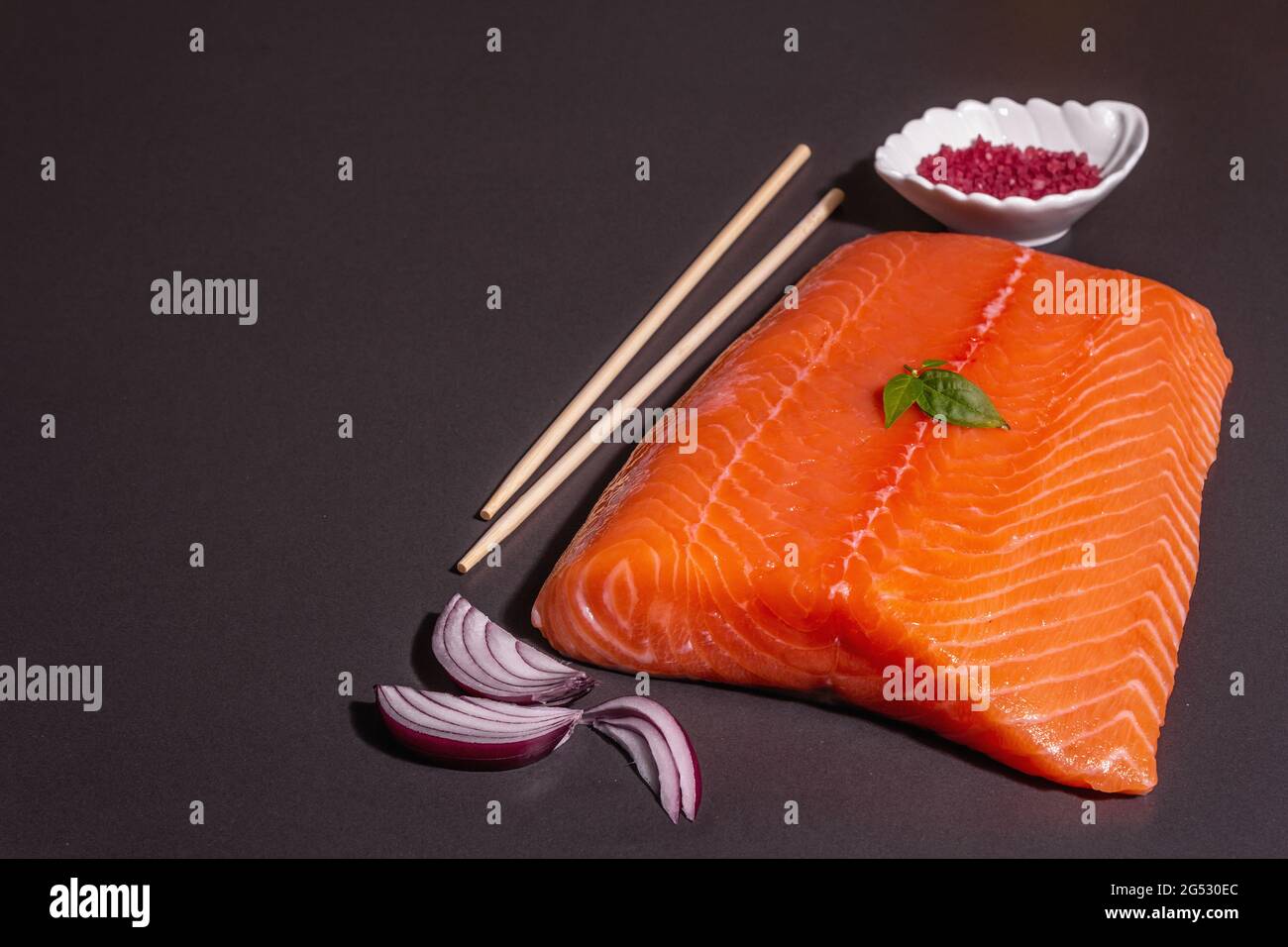 Fresh raw salmon or trout sea fish fillet on black stone background ...