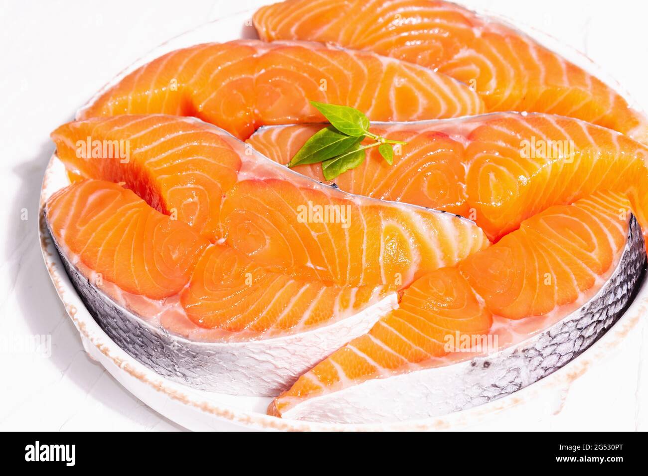 Fresh raw salmon or trout fish fillet steaks. Minimalistic design, modern  hard light, dark shadow. Chilled ingredients for cooking healthy seafood.  Wh Stock Photo - Alamy