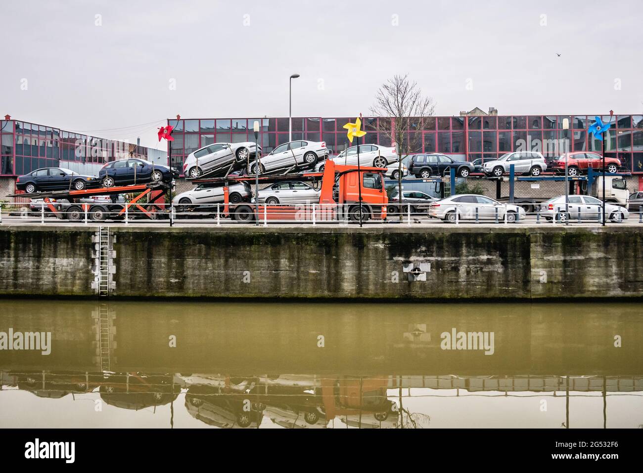 Two car shipping trailers near the channel Stock Photo