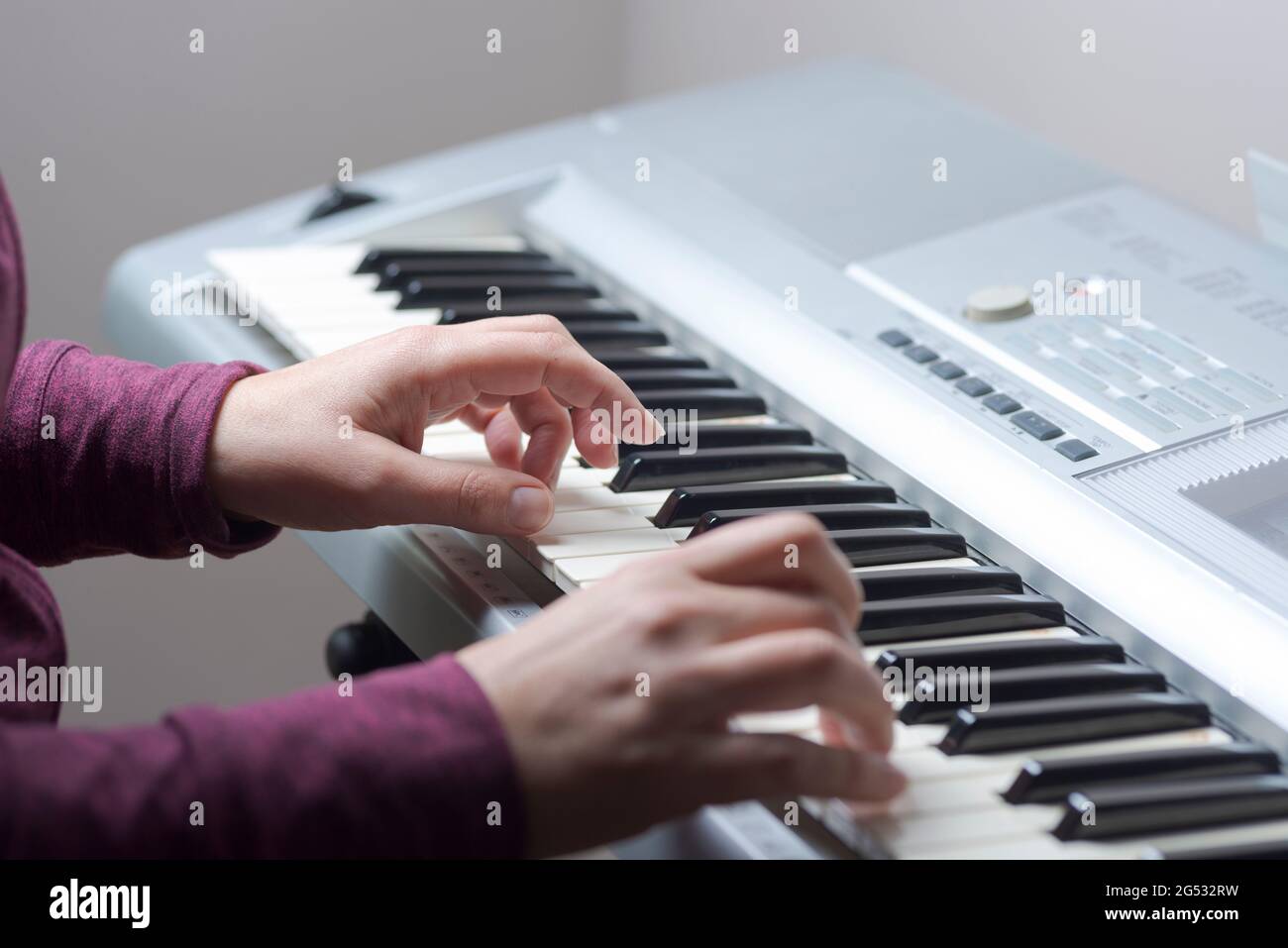 Woman plays keyboard -hands close-up Stock Photo