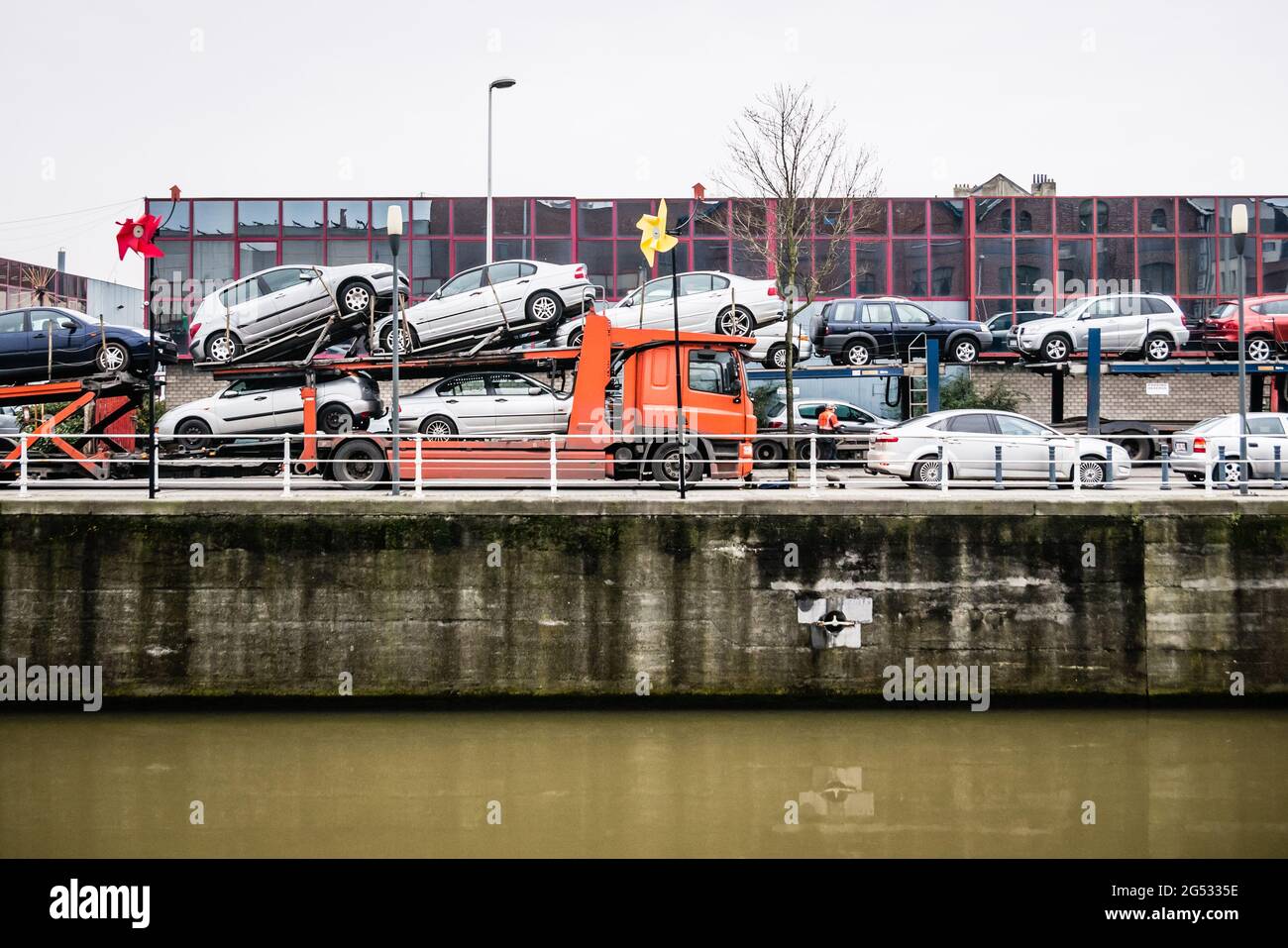 Red auto-carrier trailer near the water in Brussels Stock Photo