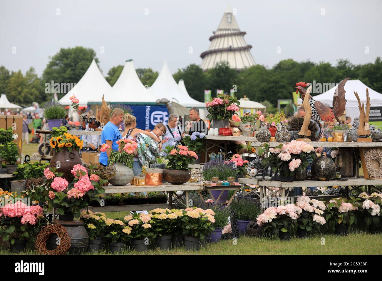 Magdeburg, Germany. 25th June, 2021. Visitors stand at a flower stand
