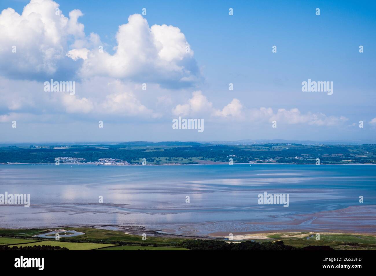 High view across Lavan Sands in Menai Strait to Beaumaris on Isle of Anglesey from above Llanfairfechan, Conwy, north Wales, UK, Britain Stock Photo