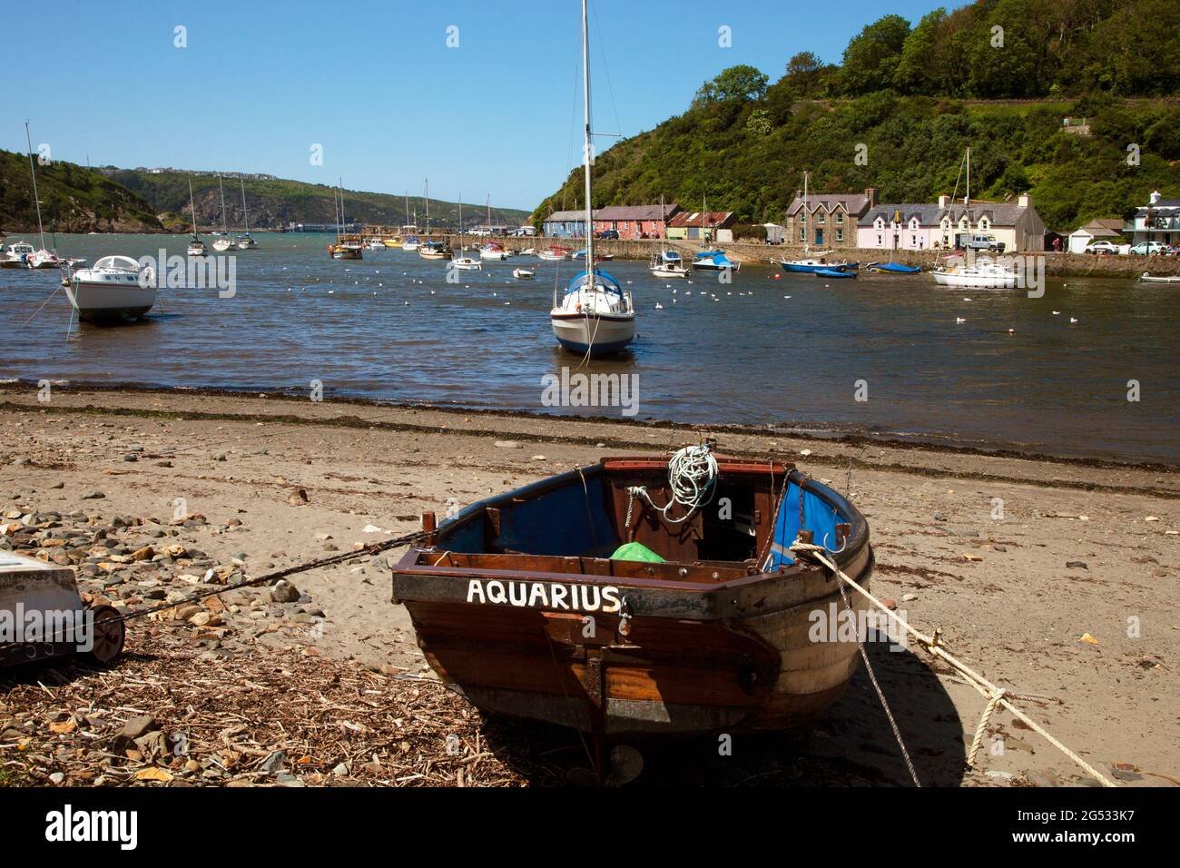 Lower Fishguard harbour Pembrokeshire, Wales, UK rowing boat in foreground summertime, daytime shot, copy space blue sky Stock Photo