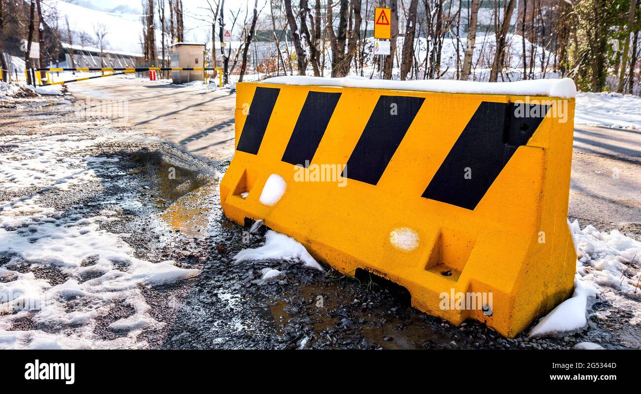 guard rail bollard on blocked read due to bad weather snow winter horizontal background Stock Photo