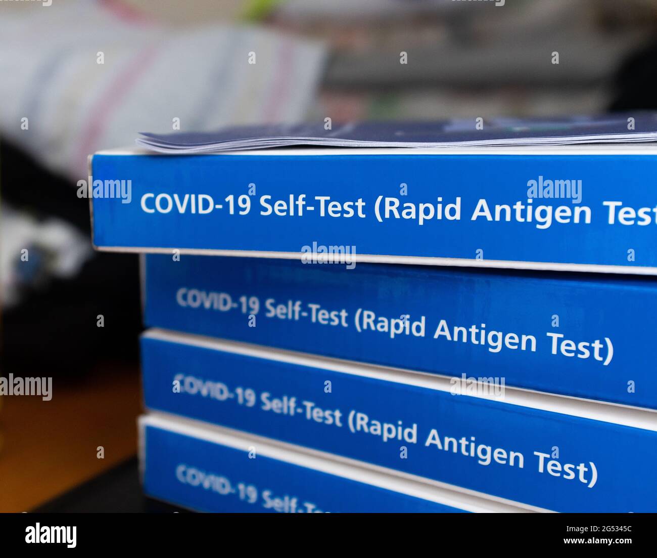 COVID-19 rapid antigen self test kits on a table Stock Photo