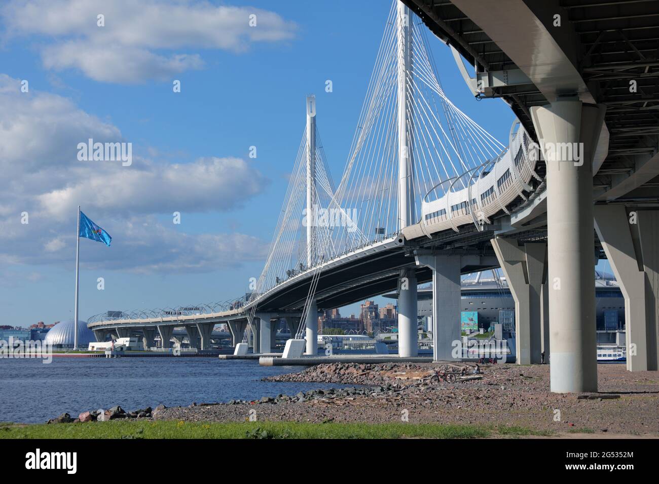 Cable-stayed bridge across Petrovsky fairway in St. Petersburg, Russia, with a flag of UEFA EURO 2020 waving at the Gazprom Arena stadium Stock Photo