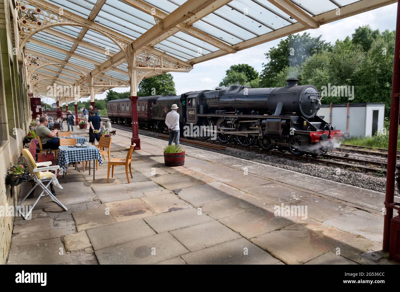 A Black Five steam locomotive is admired by visitors to Hellifield Station cafe, Hellifield, North Yorkshire, UK Stock Photo