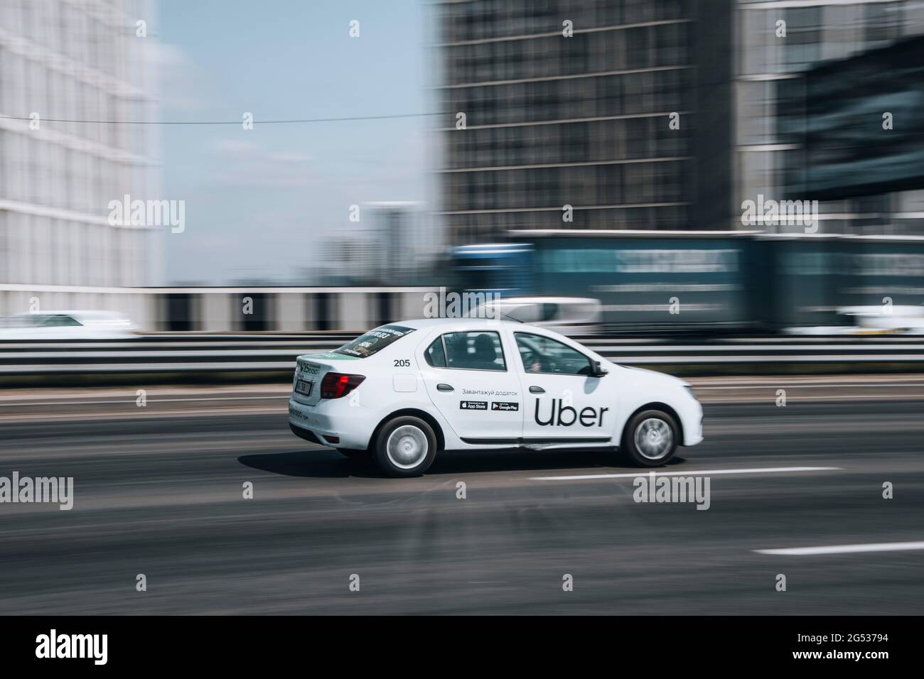 Ukraine, Kyiv - 29 April 2021: White Renault Duster Taxi Uber car moving on the street. Editorial Stock Photo