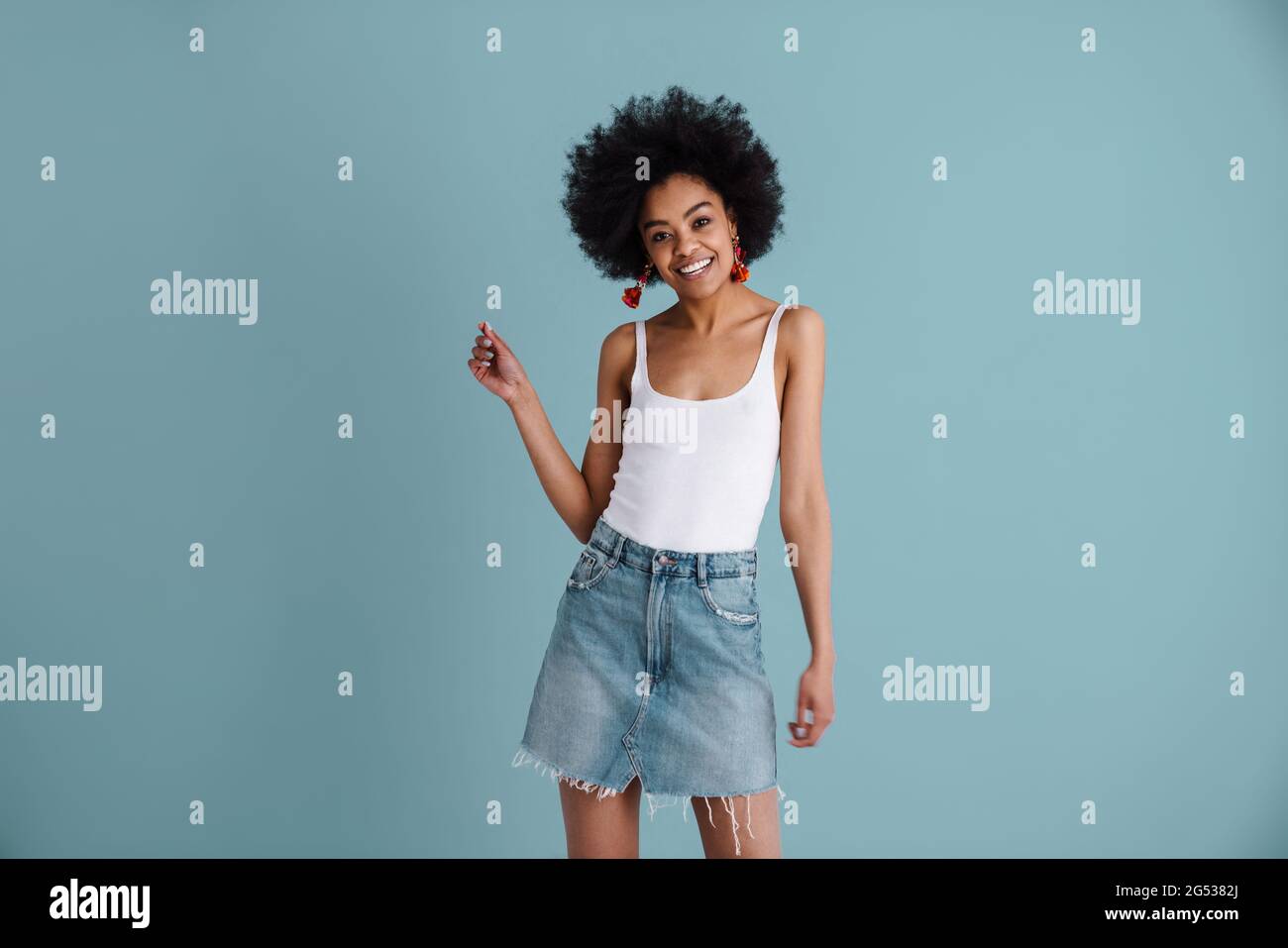 Happy african american girl smiling and looking at camera isolated over ...