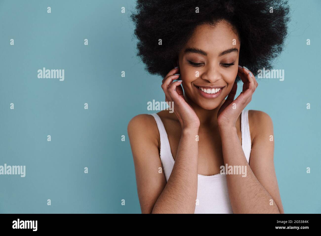 Happy african american girl posing and smiling at camera isolated over ...