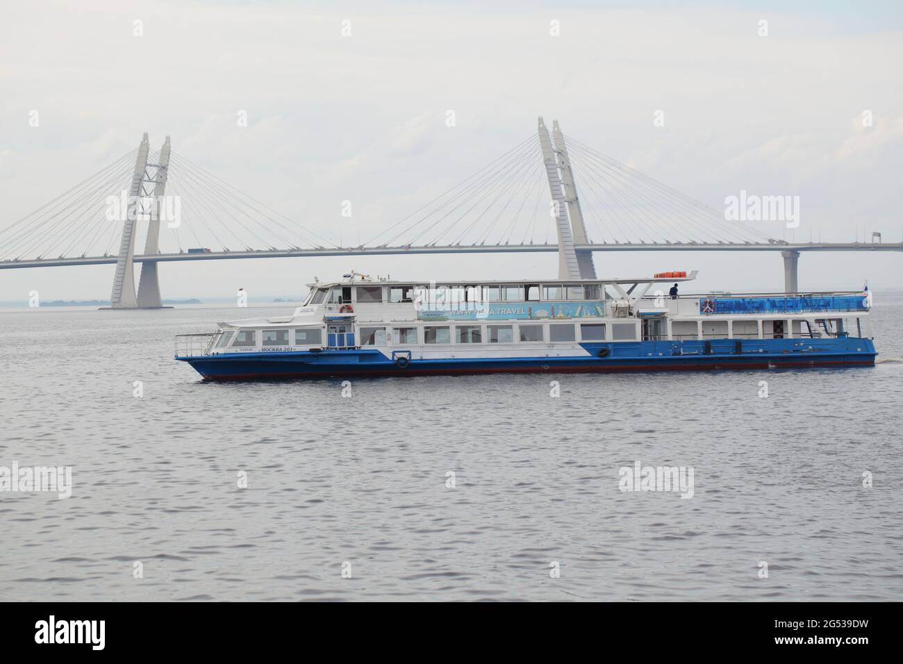Tour boat against the cable-stayed bridge across ship's fairway in St. Petersburg, Russia Stock Photo
